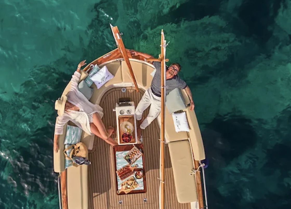 Traditional llaüt fishing boat off the coast of Mallorca, lunch served on deck