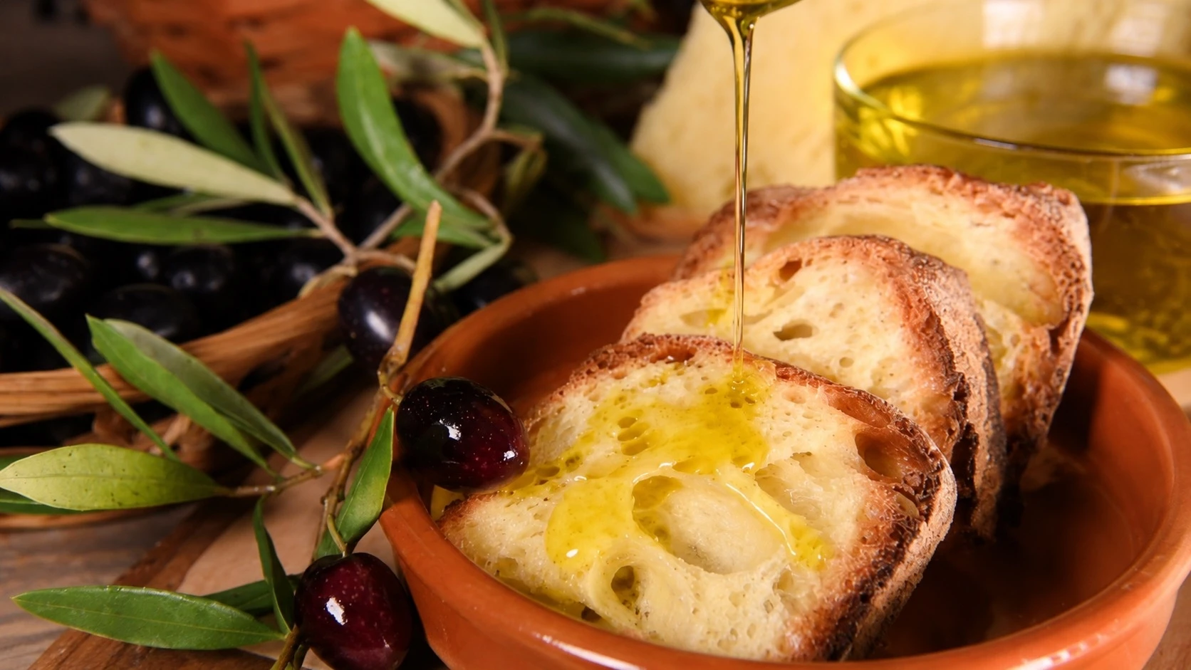 Andalusian extra virgin olive oil poured over bread during the private goldsmithing and olive oil tasting experience in Seville.